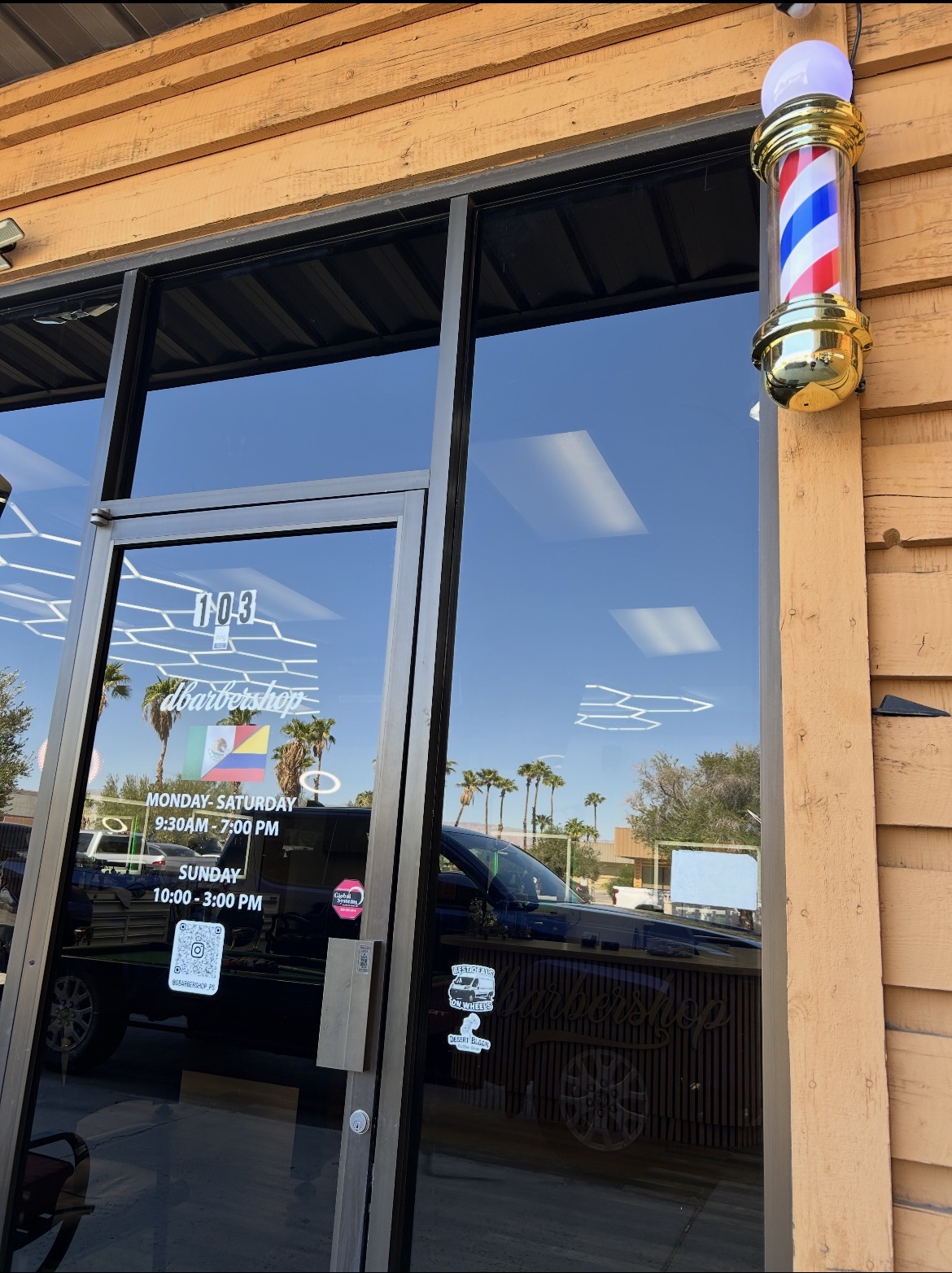 dbarbershop exterior entrance with a gold barber pole